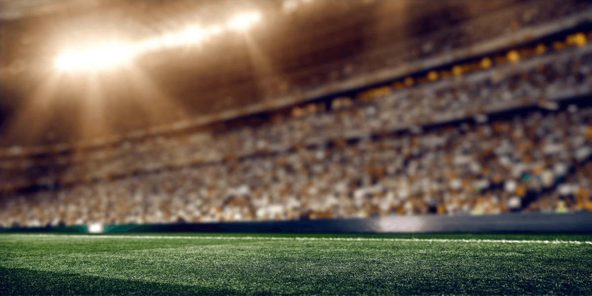 Blurry view of a stadium with bright lights and blurred crowd in the background