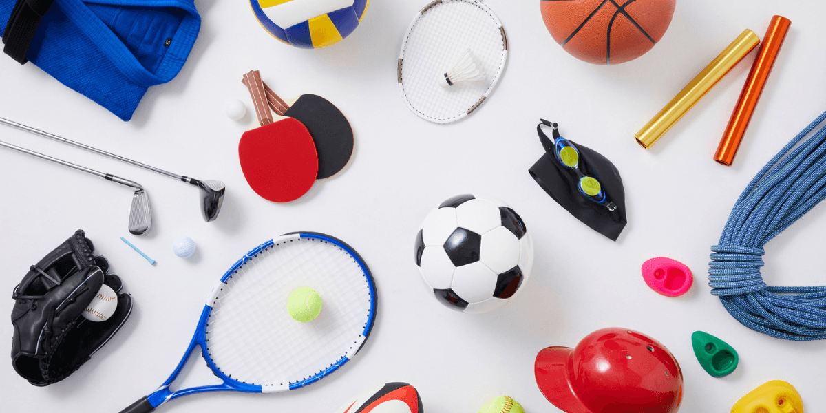 Assorted sports equipment including soccer ball, tennis racket, basketball, swimming goggles, and baseball glove on a white background.