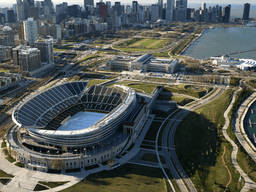 Aerial view of a stadium near a city skyline and waterfront park area