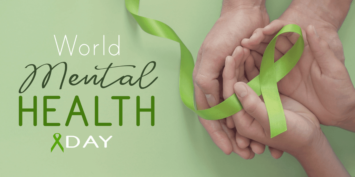 Hands holding a green ribbon, symbolizing World Mental Health Day awareness and support