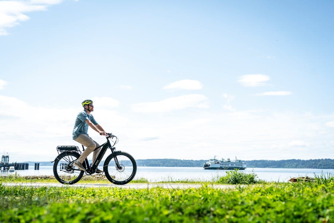Free Photo Of A Man Riding An Electric Bike On A Grassy Field