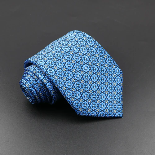 Rolled blue necktie with a small geometric floral pattern displayed against a dark background.